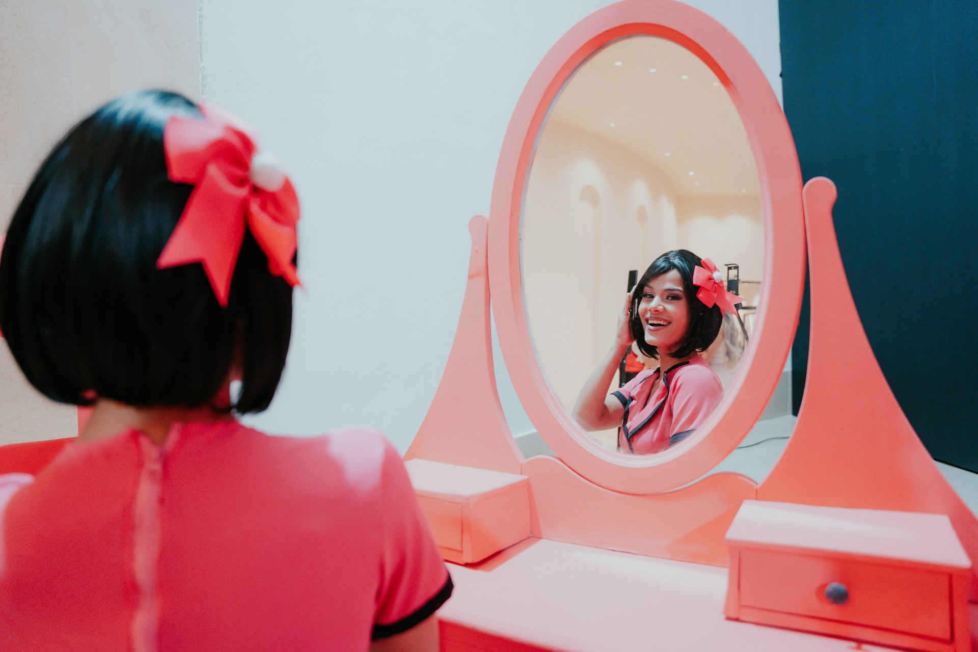a girl looking at herself in the mirror